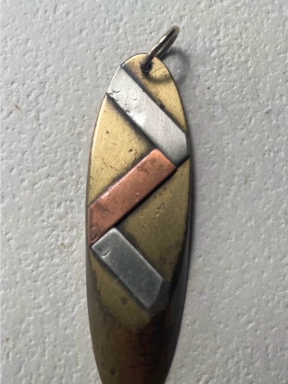 Handmade mixed-metal inlay pendant.